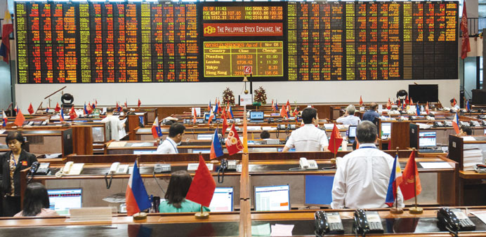 Traders work on the floor of the Philippine Stock Exchange in Manila. The bourse index gained 9.7% in March.
