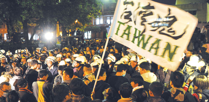 Protesters and riot police scuffle after students stormed the Executive Yuan building during a protest in Taipei yesterday.