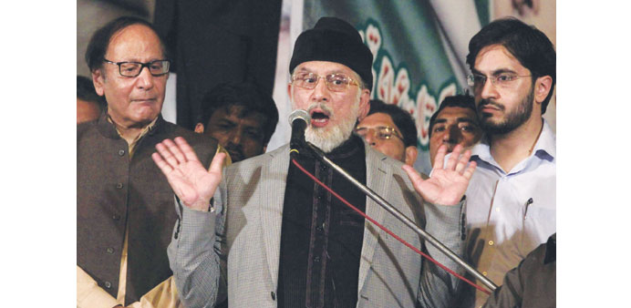 Pakistan Awami Tehreek leader Tahir ul-Qadri gestures during a speech in front of Parliament in  Islamabad yesterday.