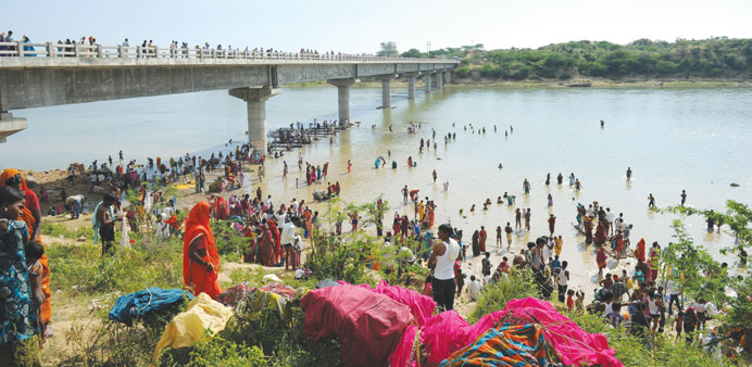 Pilgrims take a u2018holy dipu2019 yesterday in the Sindh river alongside the bridge where a deadly stampede took place the previous day near the Ratangarh te
