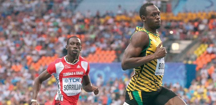 Jamaicau2019s Usain Bolt (R) and Trinidad and Tobagou2019s Rondel Sorrillo finish the menu2019s 100 metres heat at the 2013 IAAF World Championships at the Luzhni