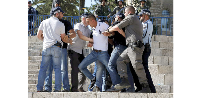 Israeli police officers scuffle with a Palestinian as they disperse a protest near Damascus Gate outside Jerusalemu2019s Old City yesterday.
