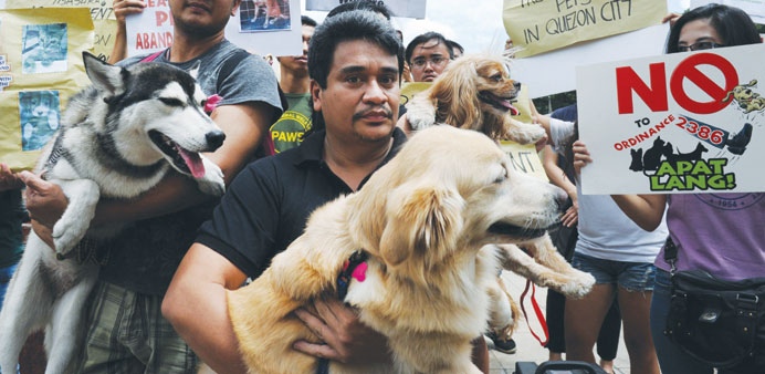Animal owners and activists hold a protest outside the Quezon City hall in suburban Manila yesterday. 