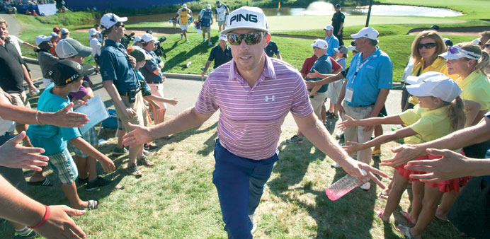 Hunter Mahan of the US greets fans as he walks off the eighteenth green at the Canadian Open golf tournament at the Glen Abbey Golf Club in Oakville o