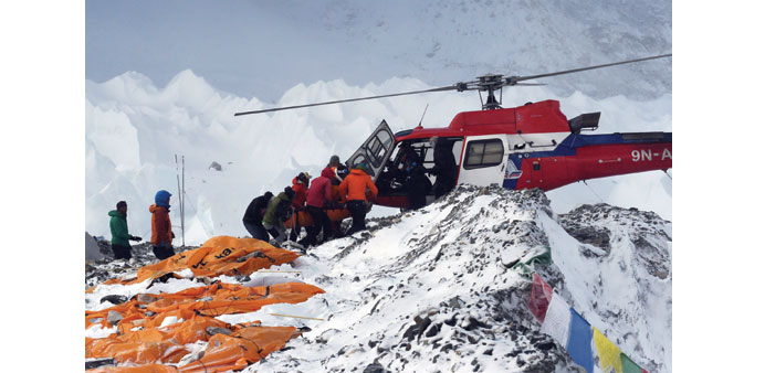 An injured person is loaded onto a rescue helicopter at Everest Base Camp yesterday, a day after an avalanche triggered by an earthquake devastated t