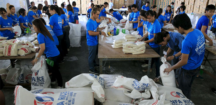 Volunteers repack food rations for victims of Typhoon Noul 