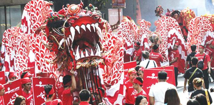 A 65m long dragon prowls Quintin Parades Street in Manilau2019s Binondo district to mark the start of New Year celebrations yesterday.
