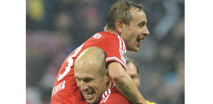 Bayern Munichu2019s Arjen Robben (right) celebrates with Rafinha after scoring against Eintracht Frankfurt at the Allianz Arena in Munich, yesterday. (AFP