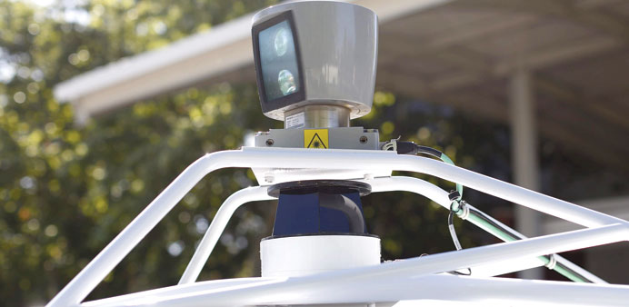 A sensor is seen spinning atop a Google self-driving vehicle before a presentation at the Computer History Museum in Mountain View, California yesterd