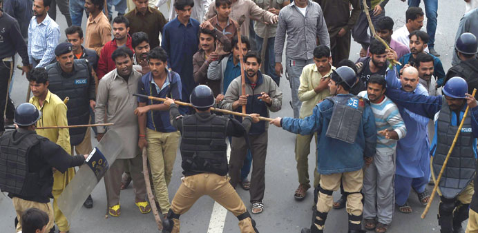 Pakistani police and demonstrators clash during a protest in Lahore yesterday.