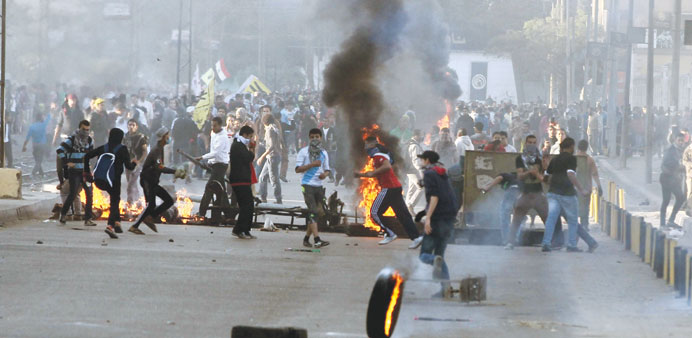 Supporters of the Muslim Brotherhood clash with security forces in Cairo yesterday.
