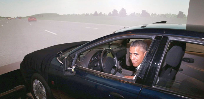 President Barack Obama sits behind the wheel of a driving simulator while touring the Federal Highway Administrationu2019s Turner-Fairbank Highway Researc