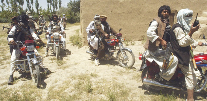 In this file photo, Taliban fighters ride on motorbikes in an undisclosed location in Afghanistan.
