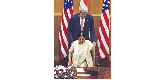 US Secretary of State John Kerry pulls a chair for External Affairs Minister Sushma Swaraj upon their arrival to address a joint news conference in Ne