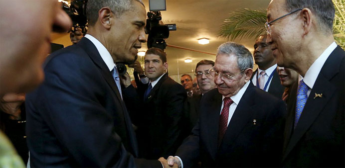US President Barack Obama (L) and his Cuban counterpart Raul Castro shake hands as UN Secretary General Ban Ki-moon (R) looks on