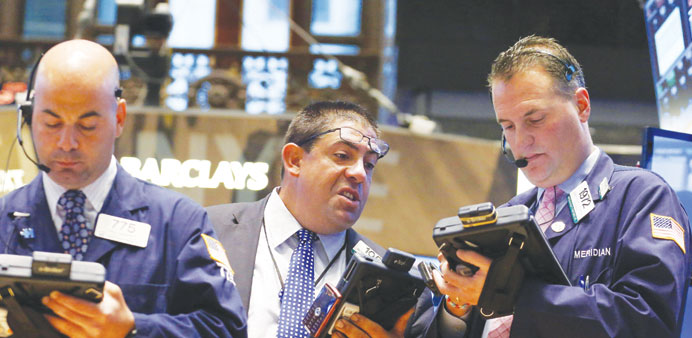    Traders work on the floor at the New York Stock Exchange yesterday. US stocks rose yesterday, helped by positive data on US factory orders in May.