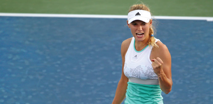 Caroline Wozniacki gestures after winning a point against Sabine Lisicki.  (AFP )