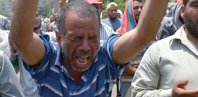 A supporter of Mursi reacts during a protest outside Rabaa al-Adawiya mosque in Cairo yesterday.