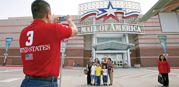 Visitors pose for a family photograph in front of an entrance to the Mall of America in Bloomington, Minnesota.