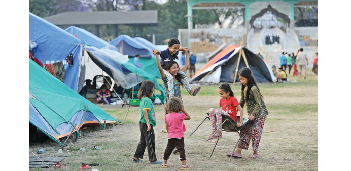 Nepalese children play at a relief camp for survivors of the Nepal earthquake in Kathmandu yesterday. The Himalayan country yesterday banned children 