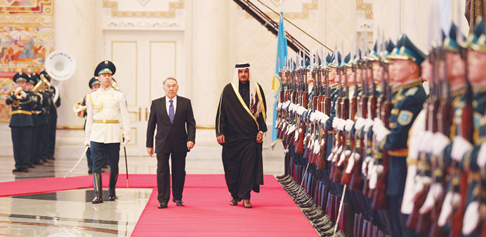 HH the Emir Sheikh Tamim bin Hamad al-Thani, accompanied by the President Nazarbayev, inspects a guard of  honour in Astana yesterday.