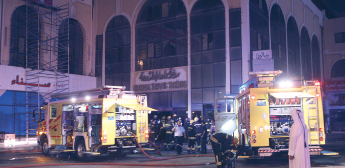 Civil Defence personnel at the site of the fire near Ras Aboud Intersection in the early hours yesterday. PICTURE: Jayaram