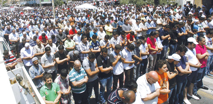 Supporters of Sunni cleric Sheikh Ahmed al-Assir perform the Friday prayers as they gather to show their support to Assir in Sidon yesterday.