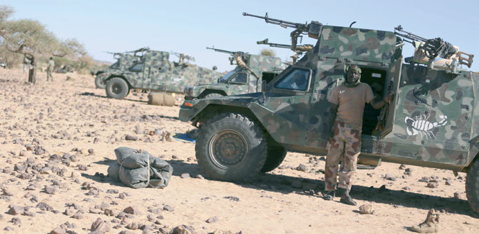 Chadian troops prepare their vehicles before patrolling in the desert near Tessalit, Mali.