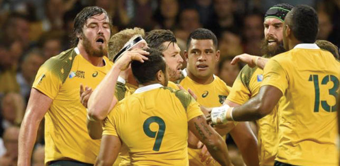 David Pocock celebrates with team mates after scoring the first try for Australia against Fiji. (Reuters)