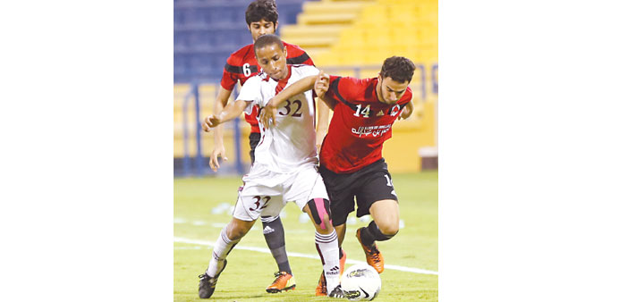  Al Rayyan's Ahmed  Alaa (R) is tackled by Al Markhiya's Ayman al-Saadi during their Sheikh Jassim Cup match yesterday.