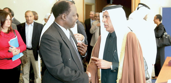 Deputy Prime Minister and Minister of State for Cabinet Affairs HE Ahmed bin Abdullah al-Mahmoud discusses a point with a delegate at the Darfur peace