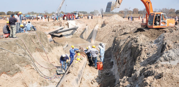 Workers repair gas pipelines after they were blown up by unidentified men near the Punjabi town of Rahim Yar Khan, about 600km south of Islamabad yest