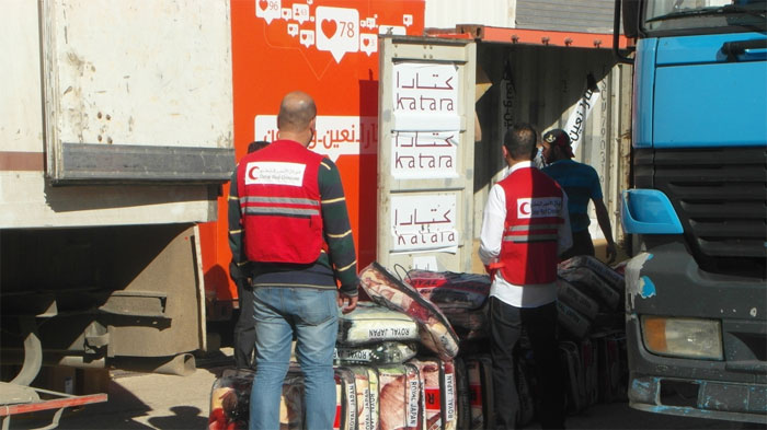 Aid materials being loaded on trucks for distribution in Syria