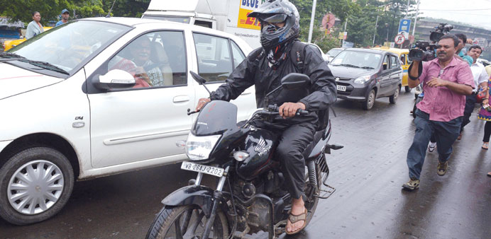 Siddharth Das tries to avoid the media as he travels on his motorcycle on a busy road in Kolkata yesterday. Das claims to be the former live-in partne