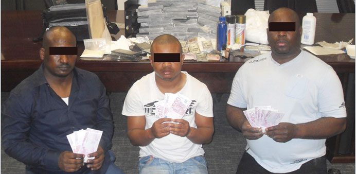 Members of the arrested gang with the fake banknotes.  