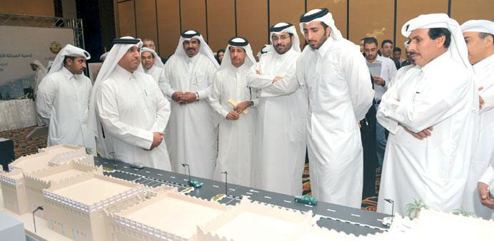 Ministers and senior officials viewing models of the projects yesterday. 