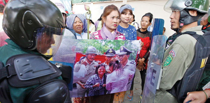 Cambodian police officers block protesters during a rally in Phnom Penh yesterday.