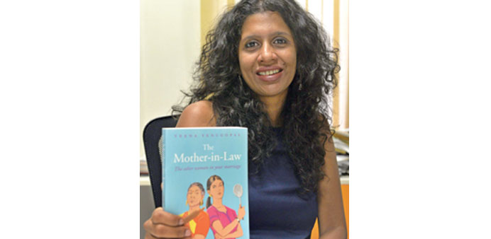 Indian writer Veena Venugopal posing with her book The Mother-in Law at her home in New Delhi.