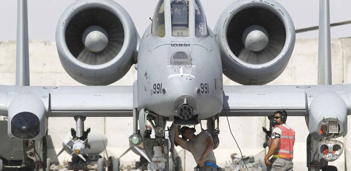 US Air Force ground staff members check an A-10 Thunderbolt II aircraft.