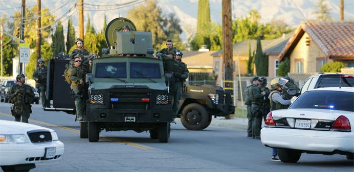 Police officers conduct a manhunt after a mass shooting in San Bernardino, California 