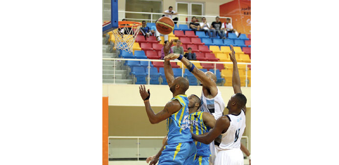 Gharafau2019s Monroe Samuel Junior (Left) shoots to basket against Al Wakrah during their Qatar Basketball League game yesterday.