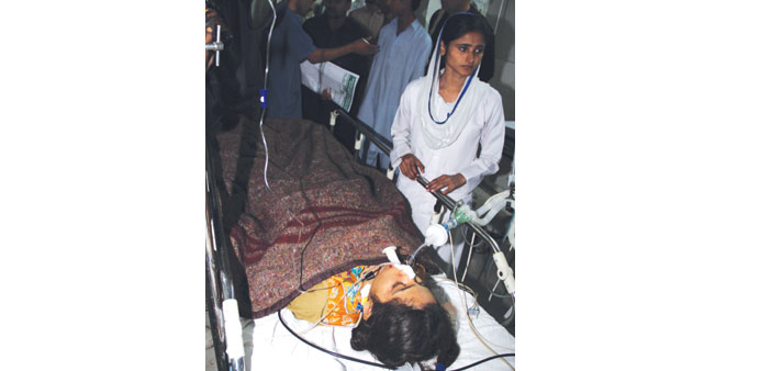 A girl who was injured in a school van accident receives medical treatment at a local hospital in Nawabshah.