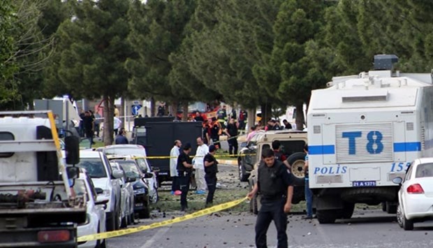 Police forensic experts examine the scene following a car bomb attack on a police vehicle in Diyarbakir on Tuesday.
