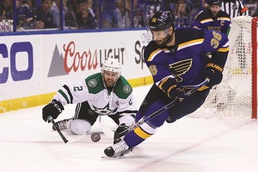 Kris Russell (No 2) of the Dallas Stars looks to clear the puck against Troy Brouwer of the St. Louis Blues in Game Six of the Western Conference Second Round during the 2016 NHL Stanley Cup Playoffs at the Scottrade Center in St. Louis, Missouri. (AFP)