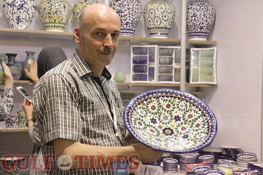 FROM THE HOLY LAND: Ziad Natsheh with his collection of blue pottery, unique to Palestinian heritage. Photo by Umer  Nangiana