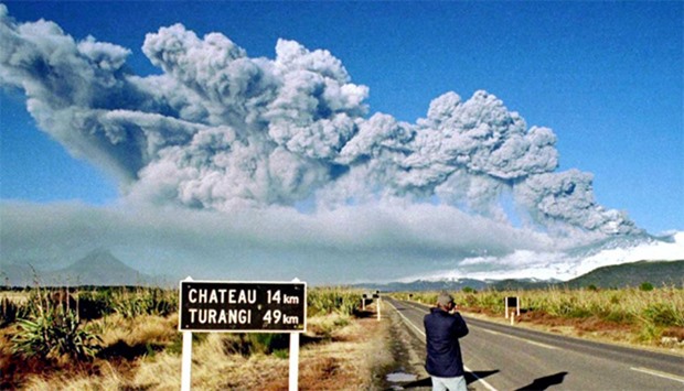 A tourist takes pictures of Mount Ruapehu as it erupts (file photo)