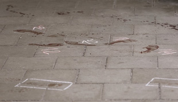 Bloodstained footprints and a trail of blood are seen on the floor of a train station after a knife attack in Grafing.