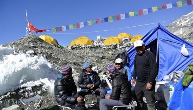 Sherpas sit at the Mount Everest base camp in this April 2014 file photo.
