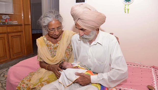 Indian parents Mohinder Singh Gill (right) and Daljinder Kaur hold their newborn baby boy Arman at their home in Amritsar on Wednesday.