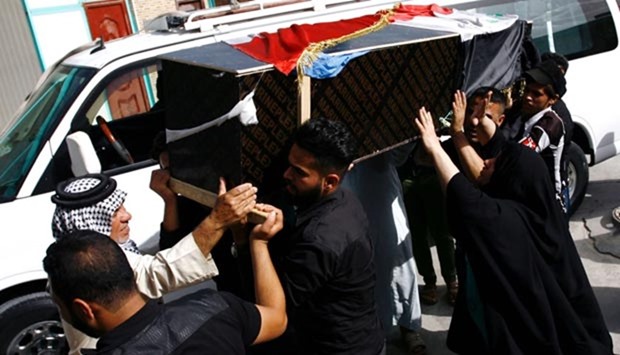 Iraqis carry the coffin of a victim of a car bombing in Sadr city on Wednesday.
